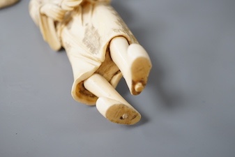 A Japanese ivory okimono, early 20th century, detached from signed base. 19cm